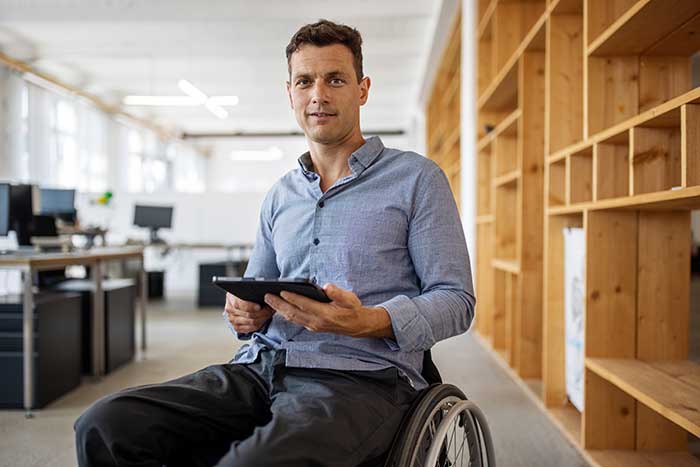 Man in a wheelchair in library